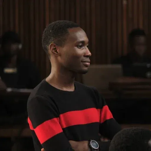 Inverse's CEO, smiling, in a black and red striped sweater