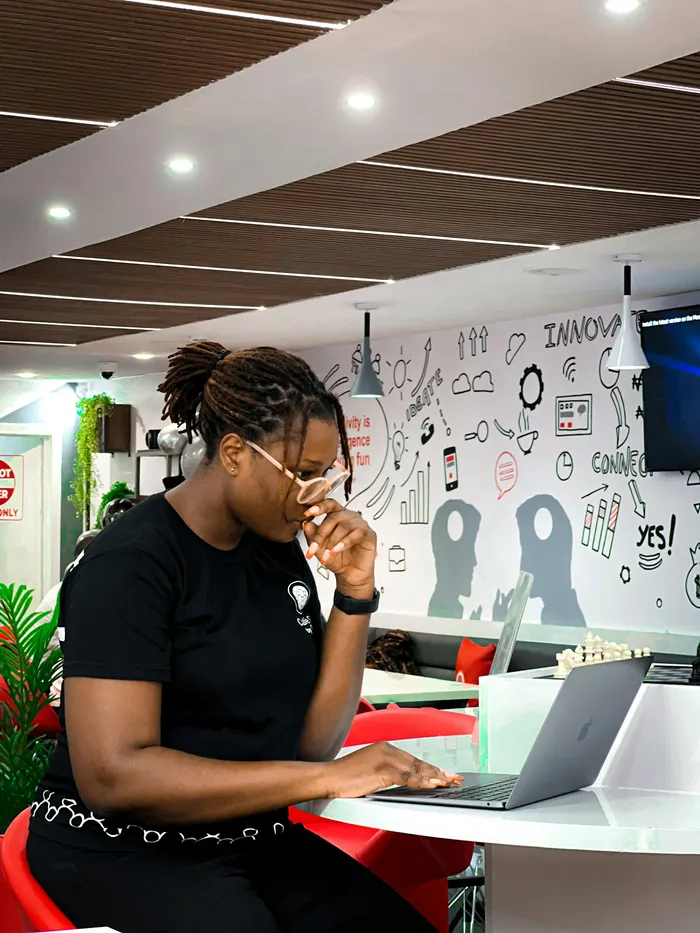 A woman working on a laptop in a colourful office