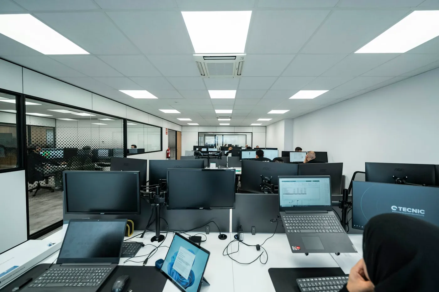 A bright open-plan office with rows of workstations