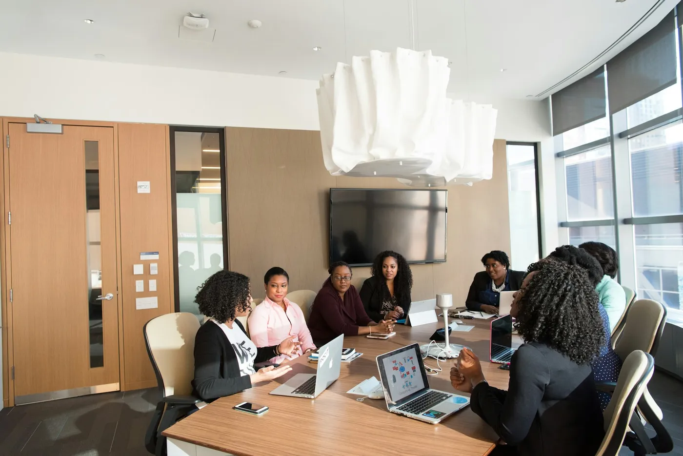 A team meeting around a table in a bright, modern office
